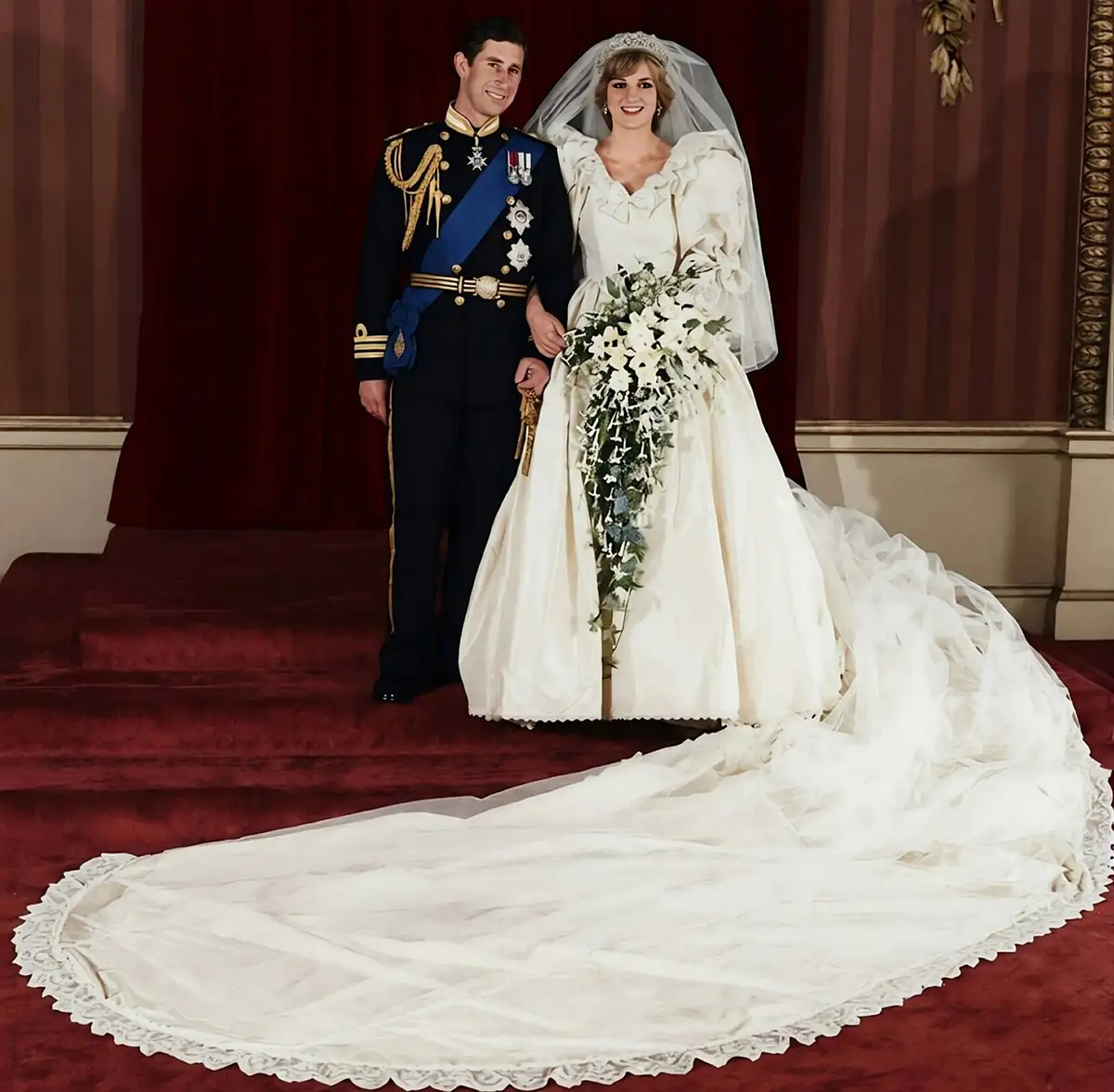 The Prince and Princess of Wales on their wedding day, July 29, 1981, with the 25-foot train spread before them.
